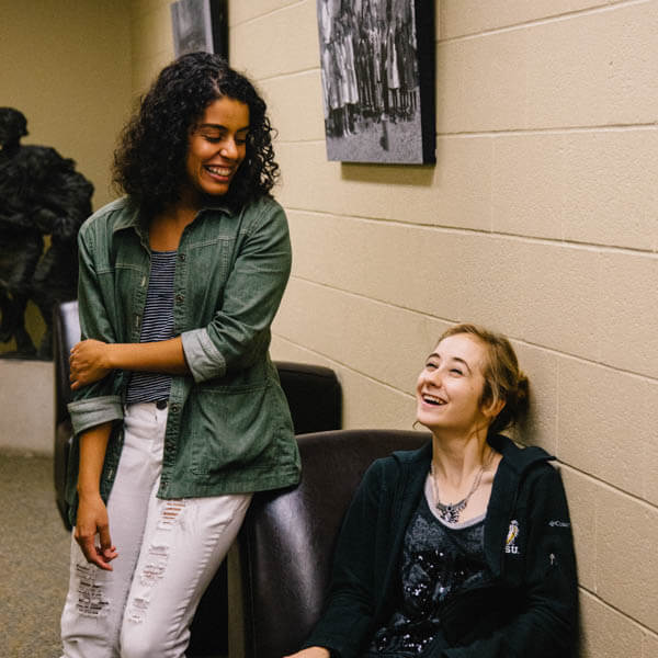 Two students chatting in Forsyth Library