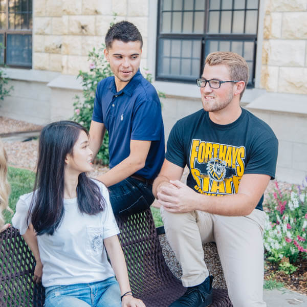 students sitting on the chair and chatting on campus