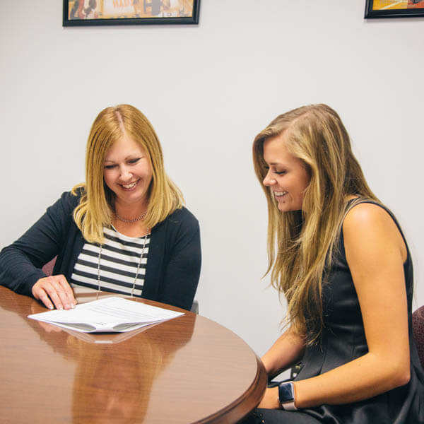 a student and her mentor talking about a paperwork