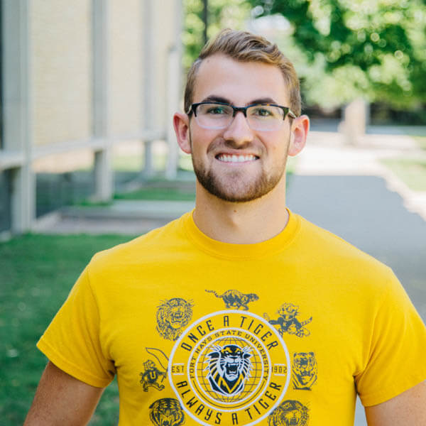 a student wearing a t-shirt on which printed once a tiger, always a tiger