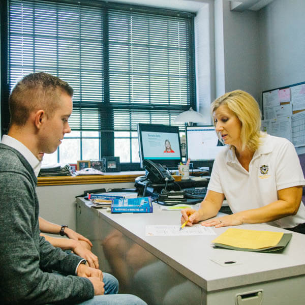 a student consulting with his transcript