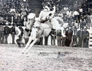 photograph of Bronc Rumsford riding a broncing horse