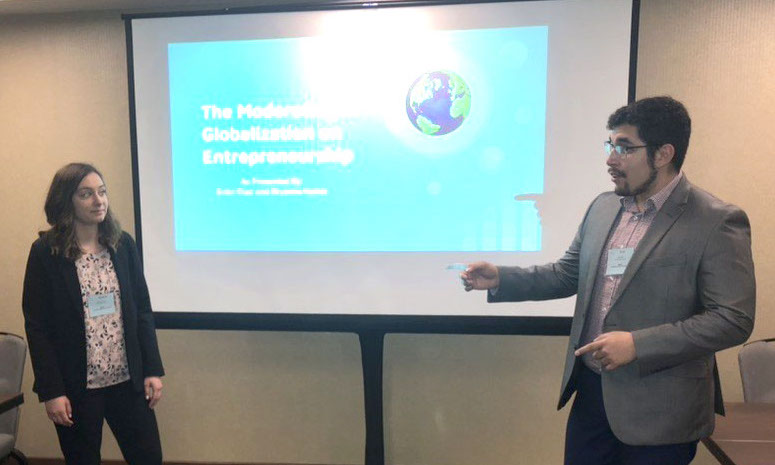 FHSU seniors Ector Diaz and Bryanna Kohler present their research project at an international business conference earlier this month.