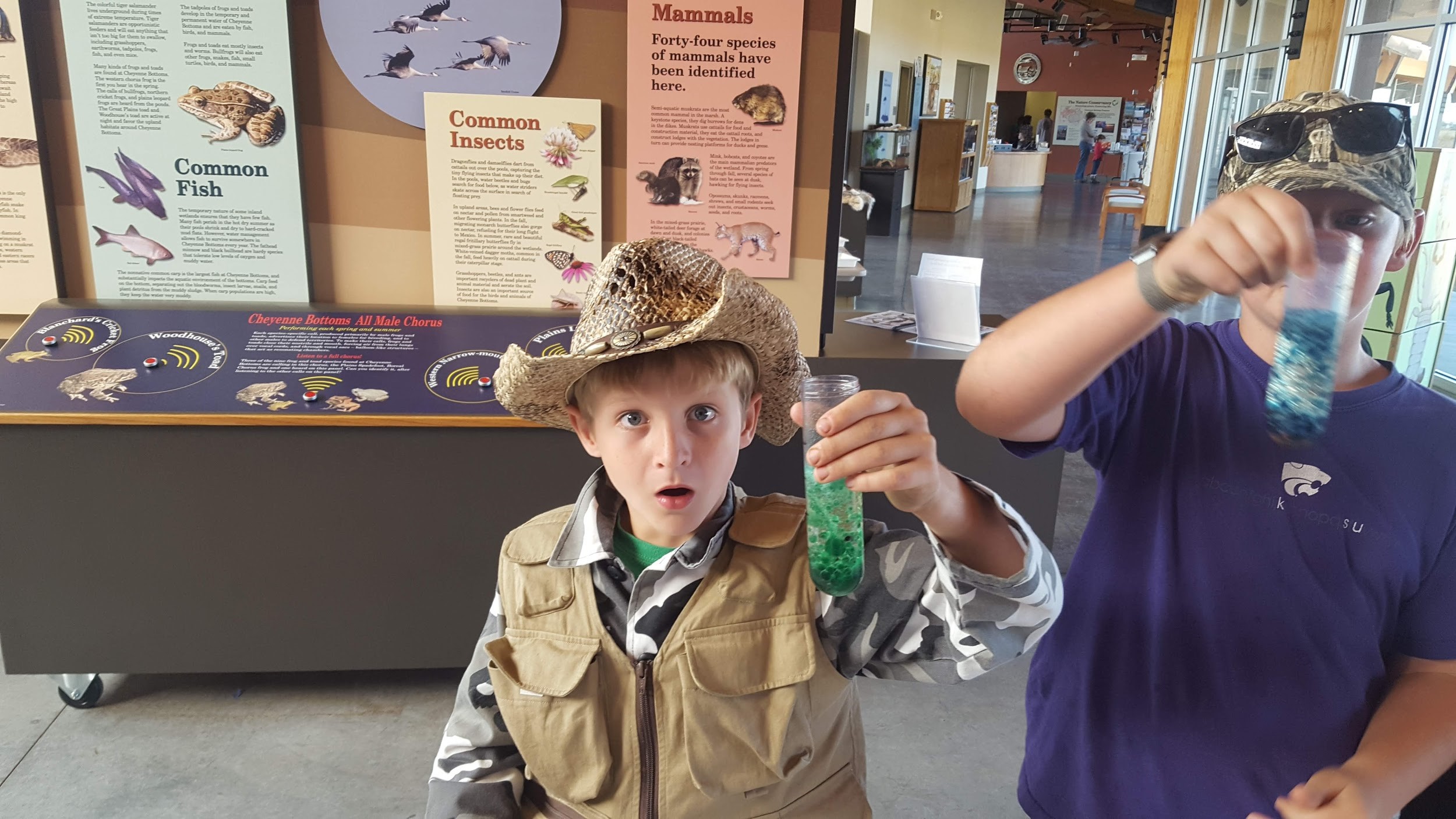 A participant from a past KWEC Drop-In STEM activity marvels at the wonders of science!