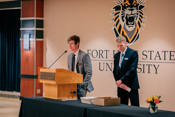 Ethan Lang, left, and Ryan Stanley – ambassadors for FHSU’s business college – thank donors for their generous support during a scholarship award ceremony on campus earlier this month.