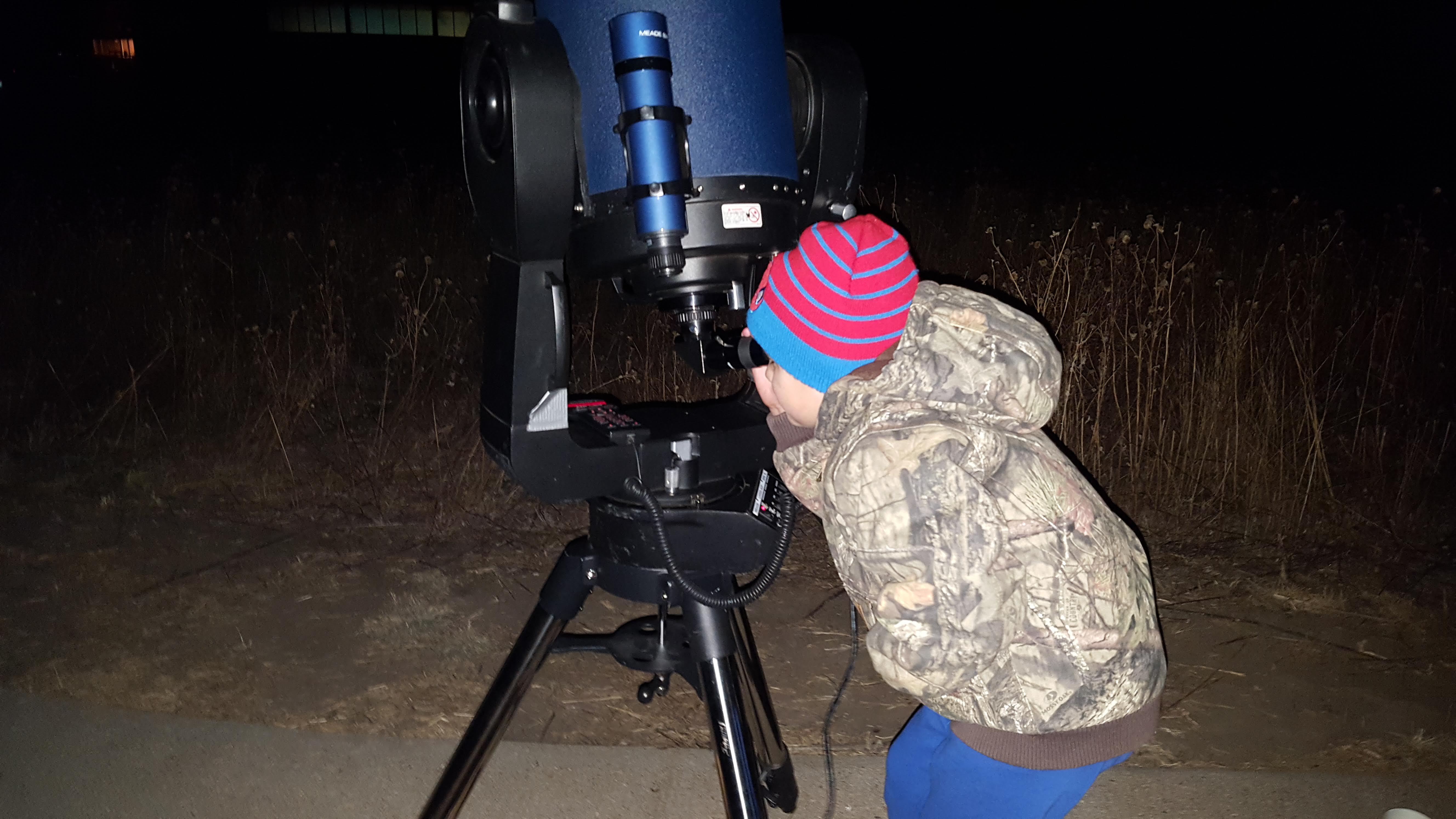 A child views deep-sky Messier Objects at a previous star gazing workshop at the Kansas Wetlands Education Center. 