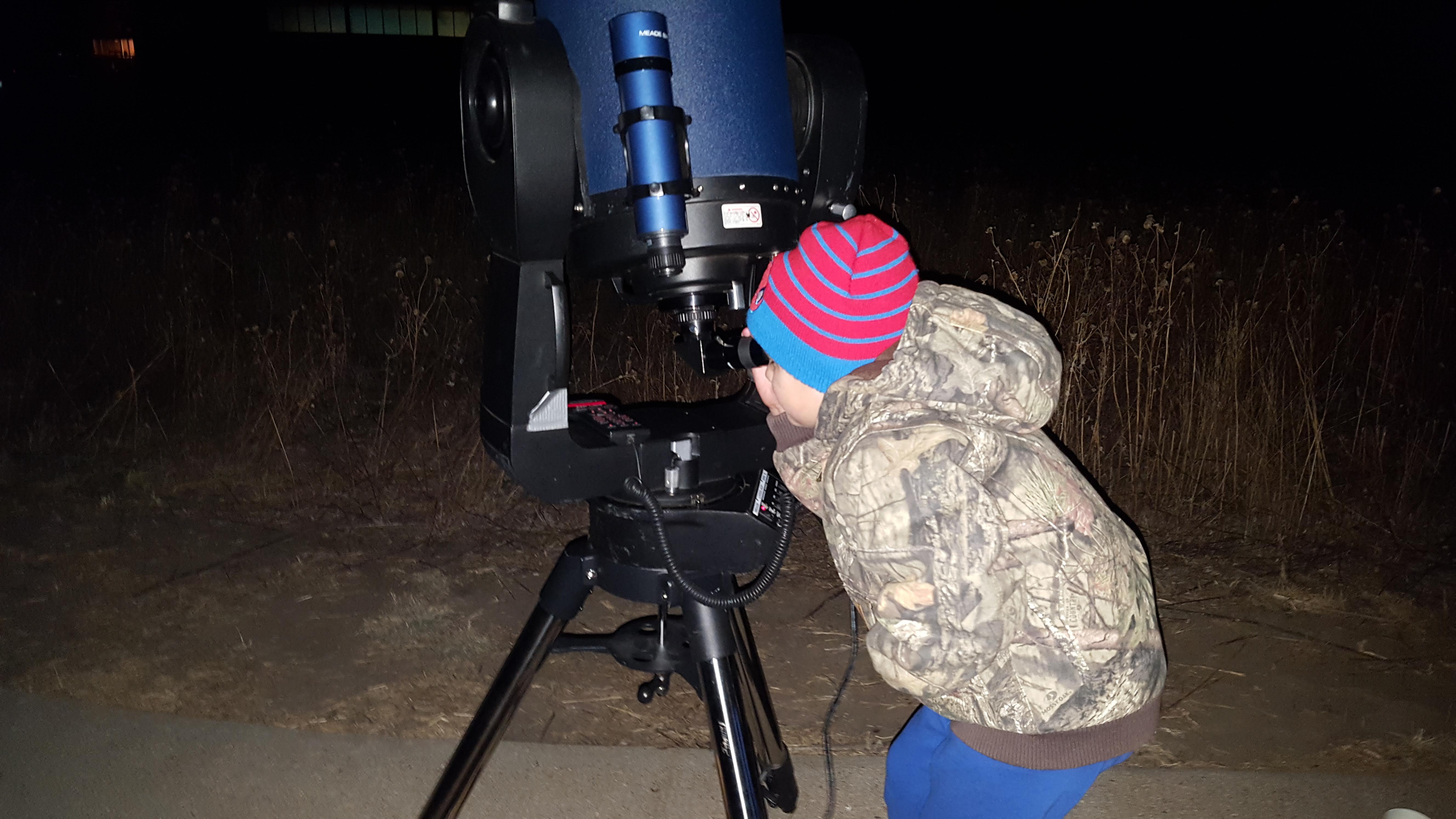 A child views deep-sky Messier Objects at a previous star gazing workshop at the Kansas Wetlands Education Center.