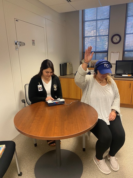 Mindi Uhland, left, and Olivia Oneslager, FHSU Communication Sciences and Disorders graduate students, practice hearing screenings.