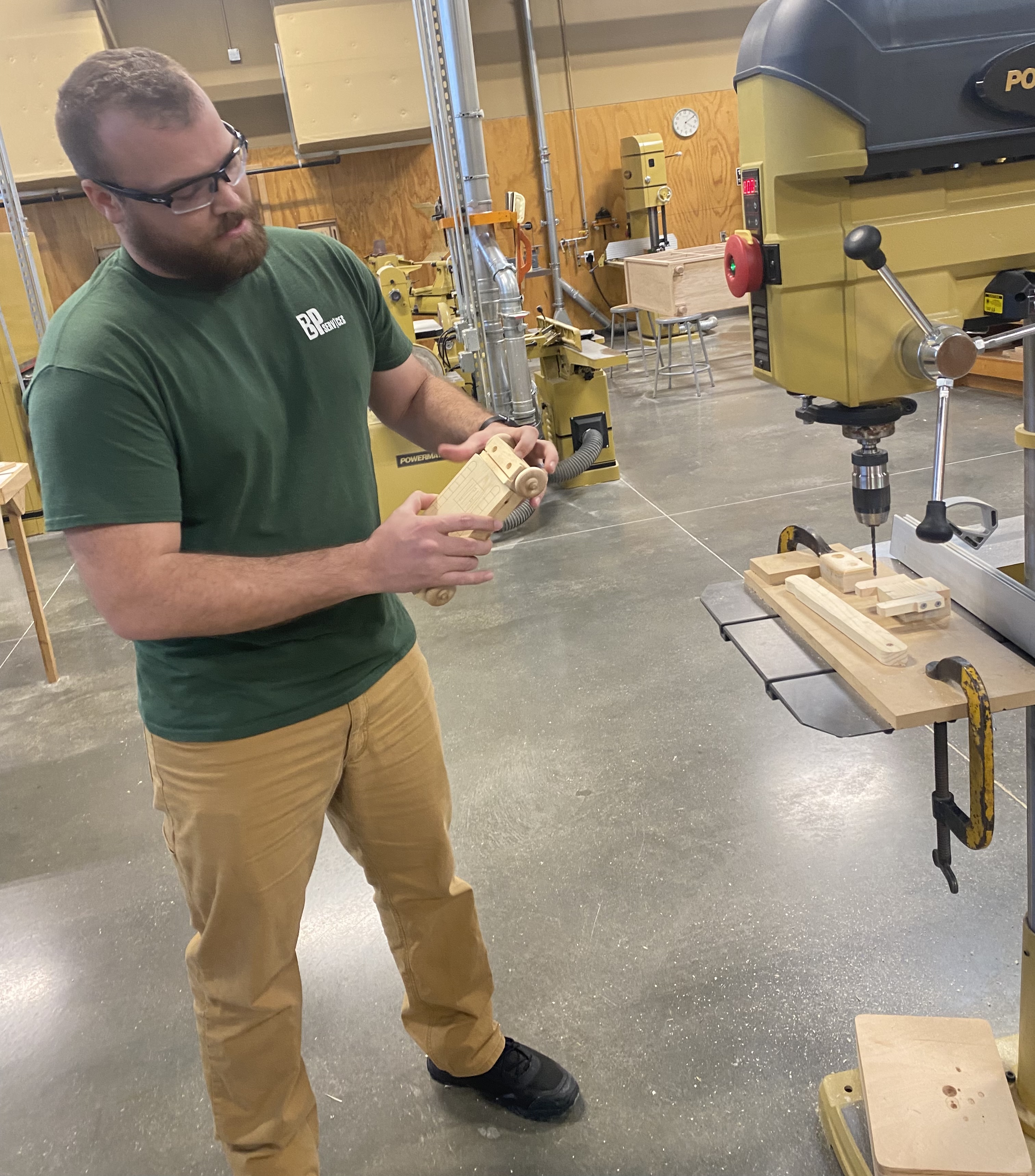 FHSU Assistant Professor Zach Pixler explains the design of the wooden toy that will be assembled at Saturday’s annual toy-building event.