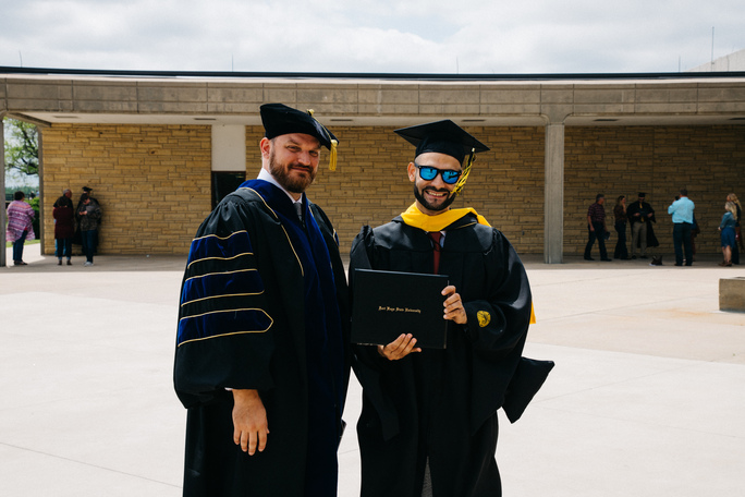 Graduate Osama Tamimi, right, from East Jerusalem, Palestine, pictured with his Fort Hays State University advisor, Jason Zeller, at last weekend’s FHSU commencement.