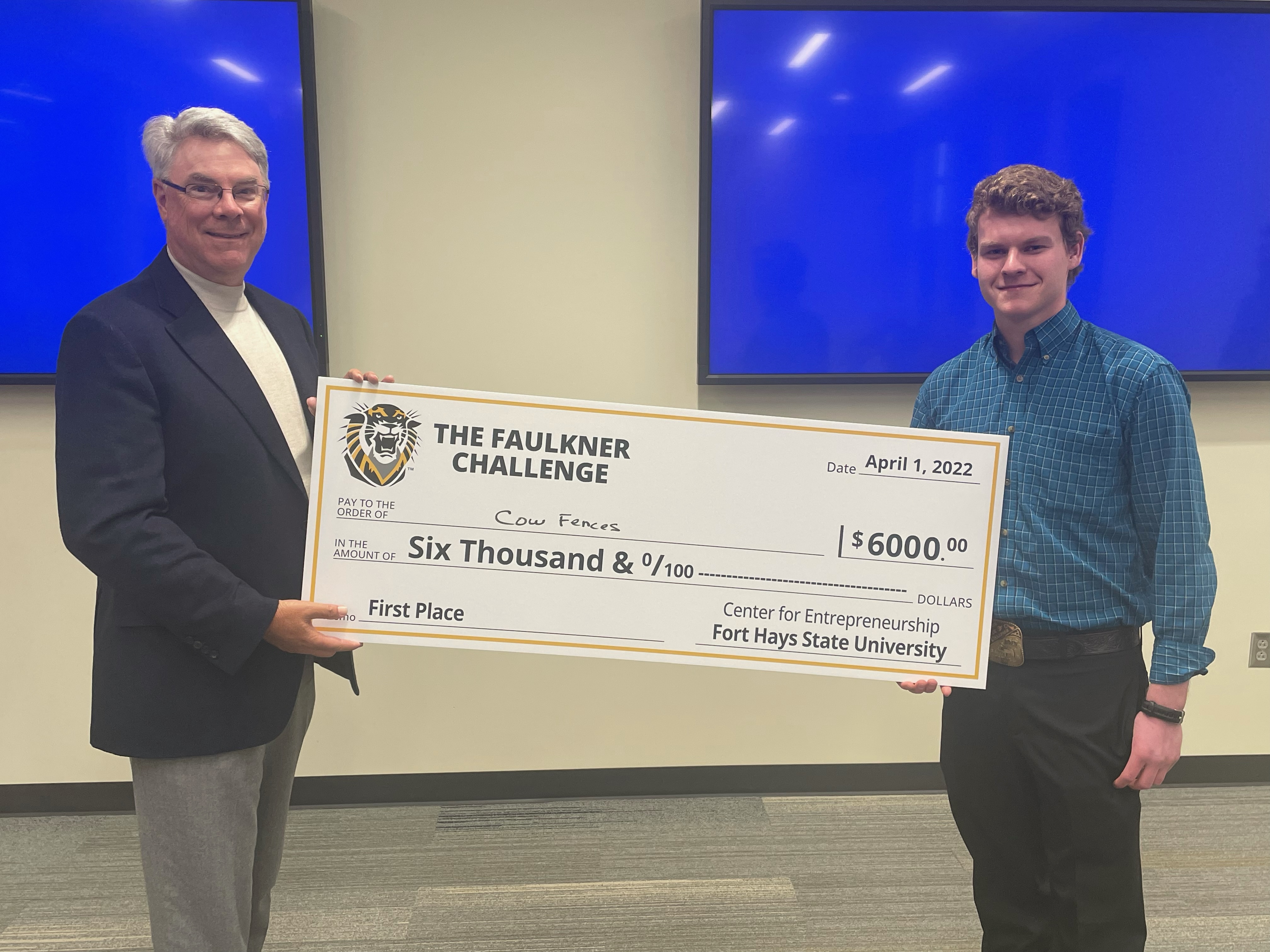 Kevin Faulkner, who wears many hats for FHSU’s Faulkner Challenge, presents Ethan McPherson with the first-place prize of $6,000 at this year’s challenge finals.