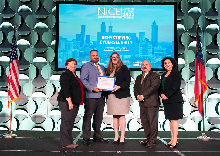 Dr. Melissa Hunsicker Walburn and Jason Zeller receiving the CAE redesignation certificate.