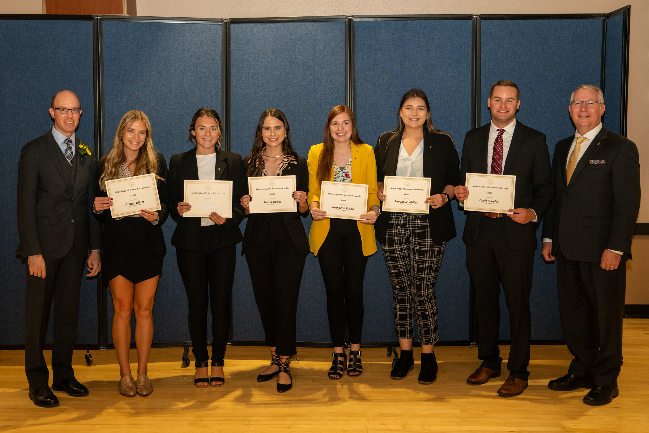 RCOBE faculty members Dr. Cole Engel and Dr. Anthony Gabel present awards to Alpha Kappa Psi business fraternity recipients.