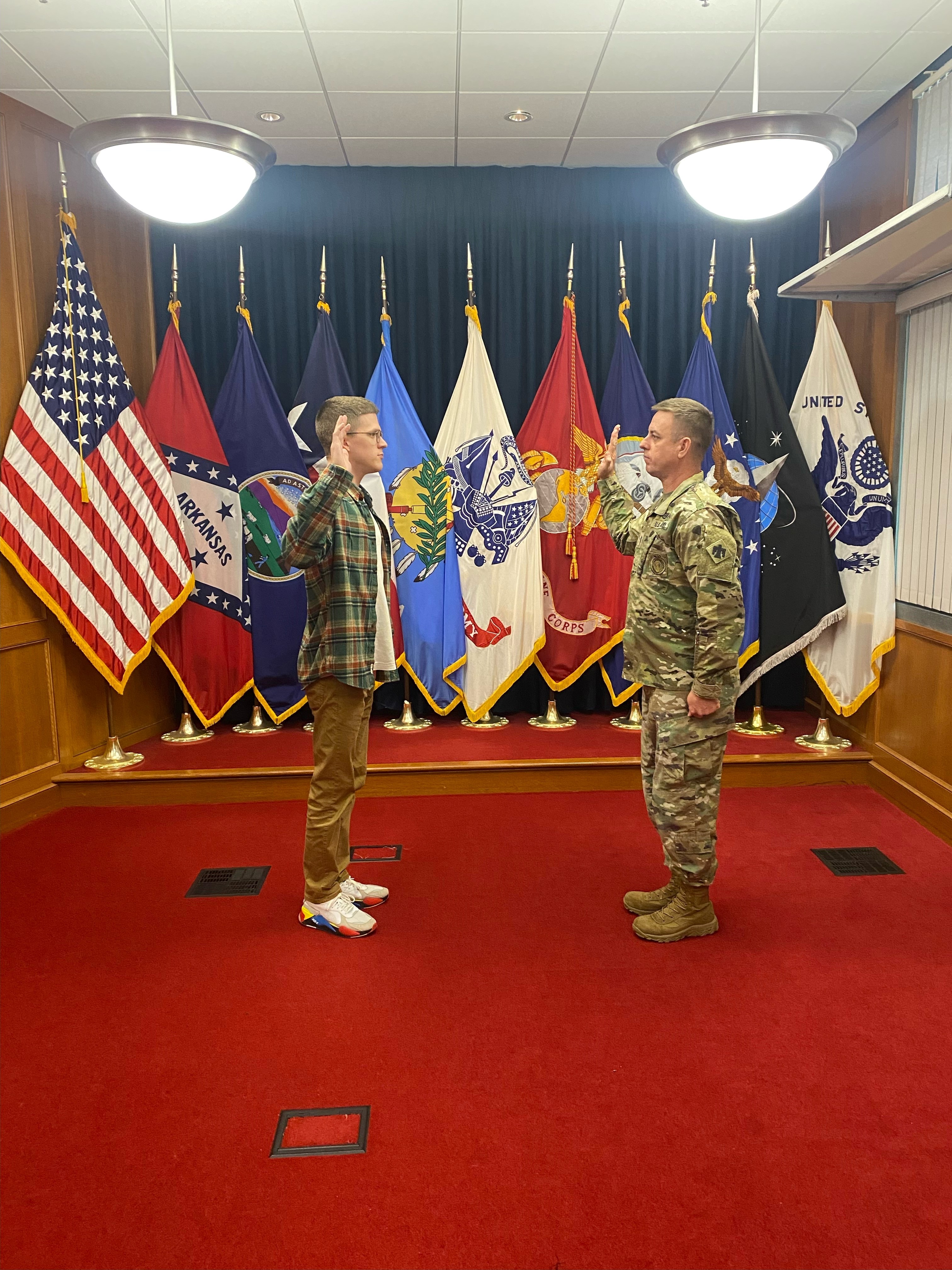 Piper raises his right hand and recites the oath to swear in to the Army.