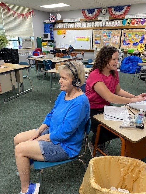 Lauren Durler, a Communication and Sciences Disorders graduate student from Syracuse, Kan. performs a hearing screening for Jeanie Beeley during a screening in Protection, Kan. in September.