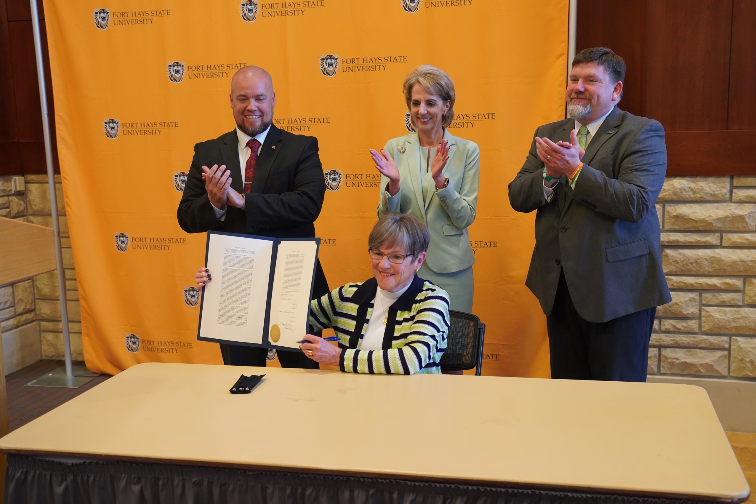 Gov. Laura Kelly ceremonially signed HB 2290 at Fort Hays State Wednesday morning. Standing behind her are Northwest Kansas Technical College President Ben Shears, FHSU President Tisa Mason, and North Central Kansas Technical College President Eric Burks 