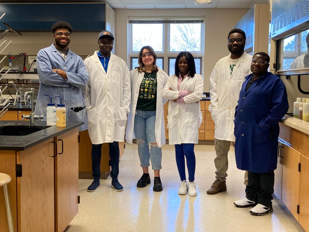 Pictured with Dr. Agbogun (second from right) are his collaborator Dr. James Titah (first from right), FHSU Geosciences Graduate students Oluwaseun Omoyemi and Olumide Ajulo and Tabor College students Tobias Stewart and Riley Collins working on a research project in Tabor College Chemistry Research Lab.