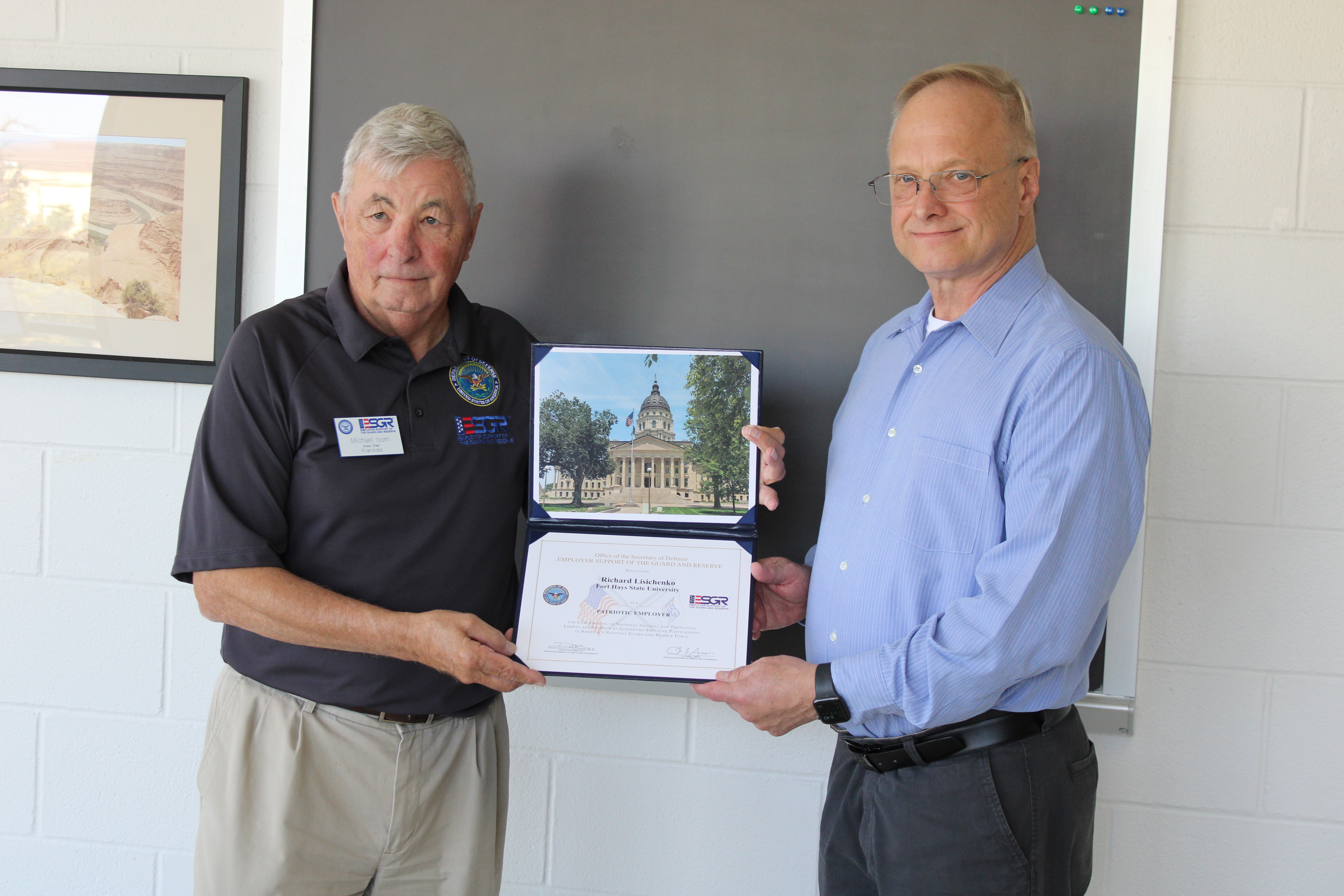 Mike Isom, left, presents the Patriot Award to Dr. Richard Lisichenko 