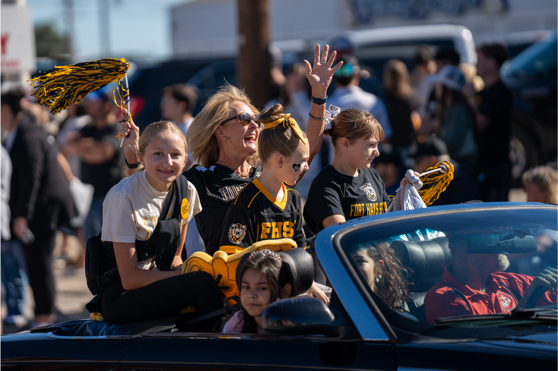 Brenda Meder, FHSU Alumni Distinguished Service Award recipient, enjoys riding in the parade with her family.
