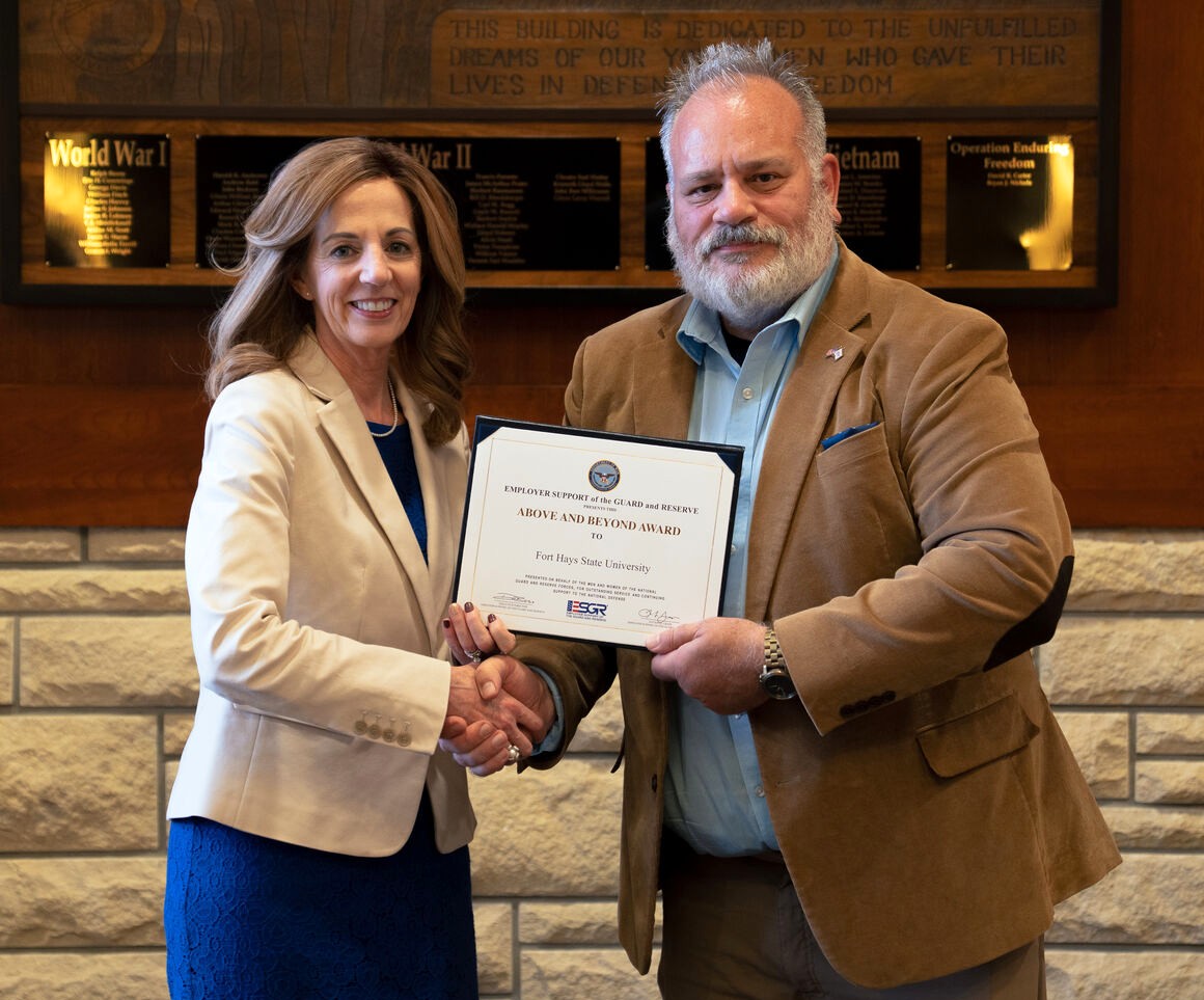 FHSU President Tisa Mason accepts the Above and Beyond award from Joe Leroux, ESGR Military Outreach Coordinator.