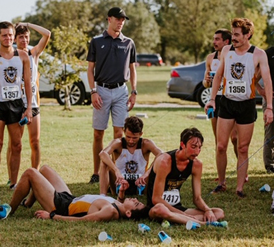 Fort Hays State University’s Brett Meyer, center back, national champion in the 1,500 meters last spring, is a graduate assistant coach for the Tiger cross country team this fall.