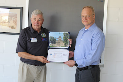 Mike Isom, left, presents the Patriot Award to Dr. Richard Lisichenko 